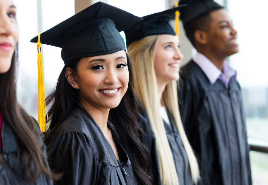 Graduates smiling towards the camera